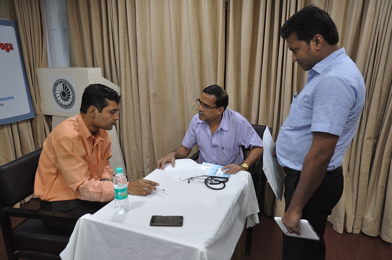 Doctor consulting community patient at health checkup camp