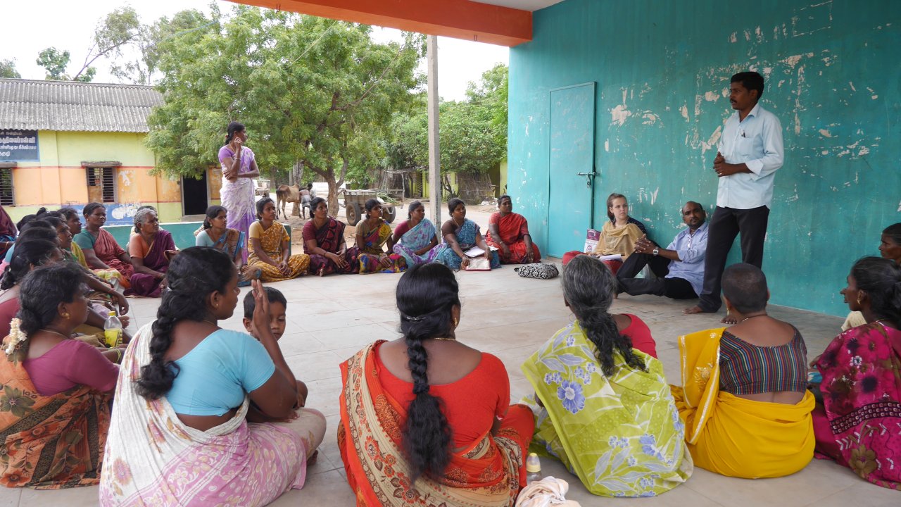 Women self-help group members and community facilitators gathered in discussion in Tamil Nadu, India
